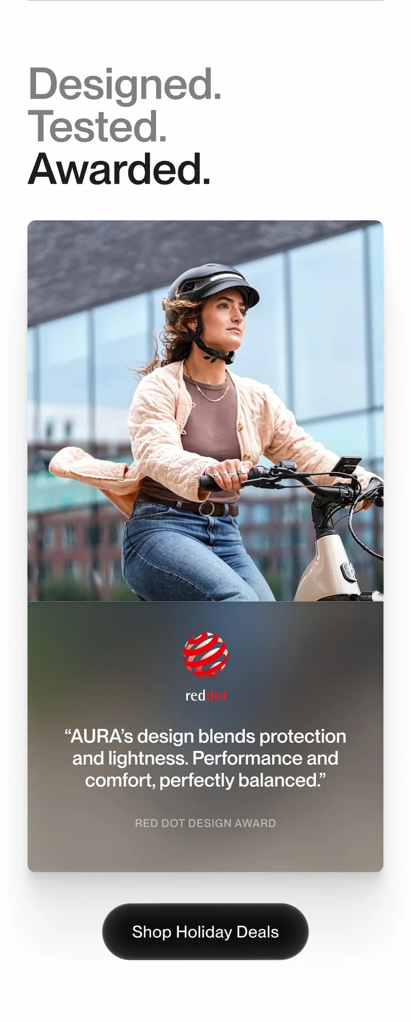 UNIT 1 AURA smart helmet on rider. Text: Designed. Tested. Awarded. Winner of the Red Dot Design Award for performance and comfort.