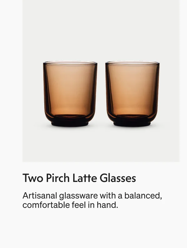 Two amber-colored latte glasses with a balanced, comfortable feel.