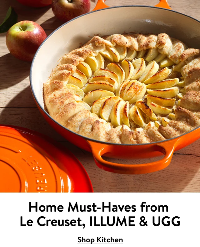 A pastry baking in an orange Dutch oven.