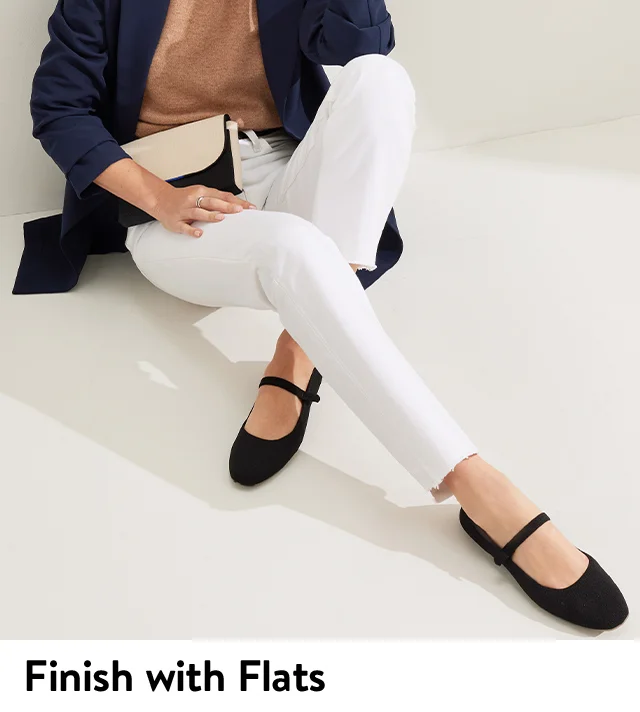 A woman wearing black mary janes.