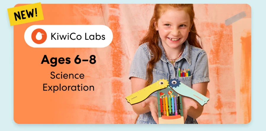 Young girl smiling while working on a science experiment from KiwiCo Labs. Hands-on STEM learning for ages 6–8.