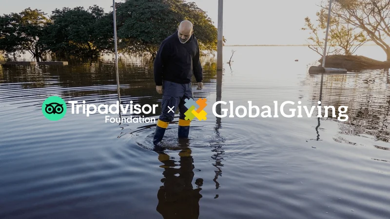 Image Description: A person walking through water with trees in the background.