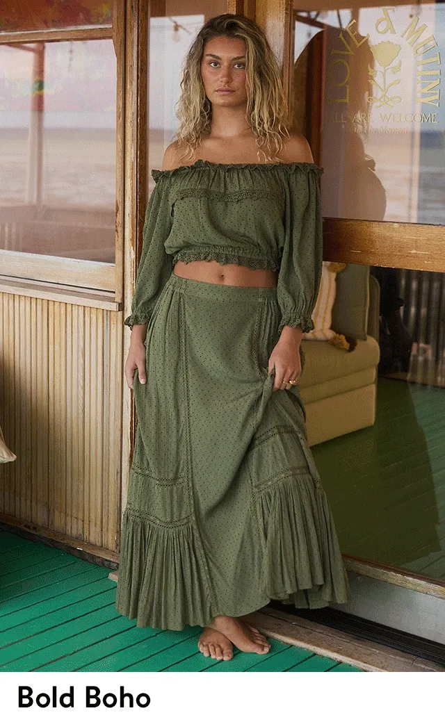 A woman wearing a green maxi skirt with a green off-the-shoulder top. A woman wearing a multi-print skirt with a matching top.