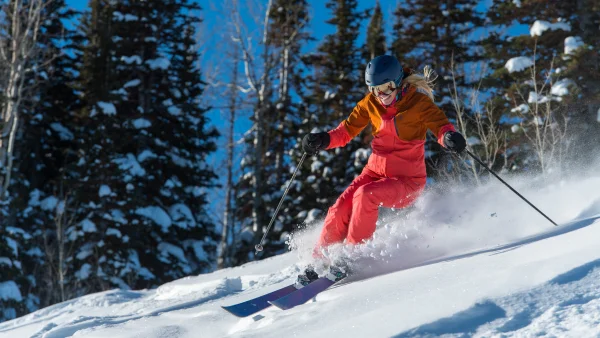 A woman skiing down a mountain.