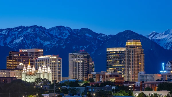 The Salt Lake City skyline at evening with the mountains in the background.