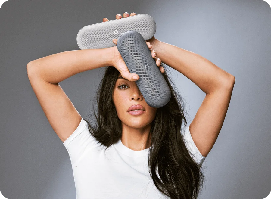 Kim Kardashian holding the Beats Pill in Light Gray and Dark Gray.