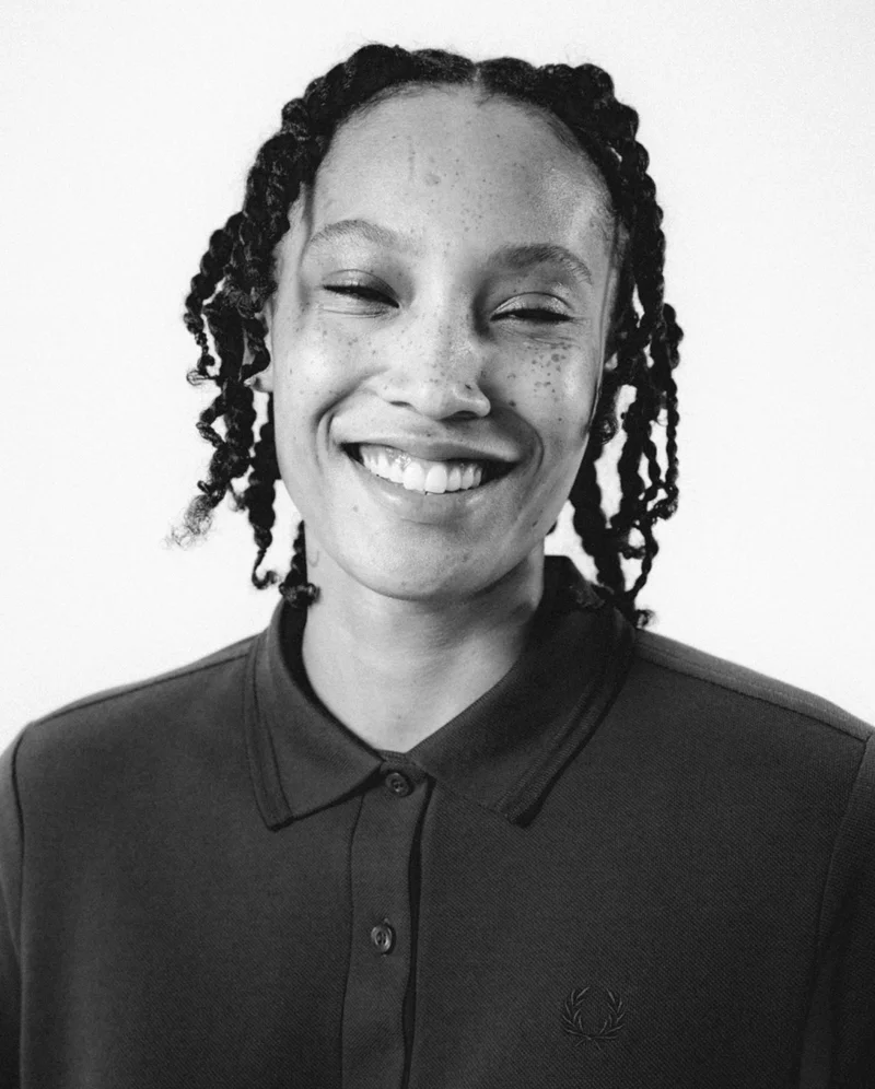 Fred Perry x George Cox - portrait of a woman in a Fred Perry Shirt smiling