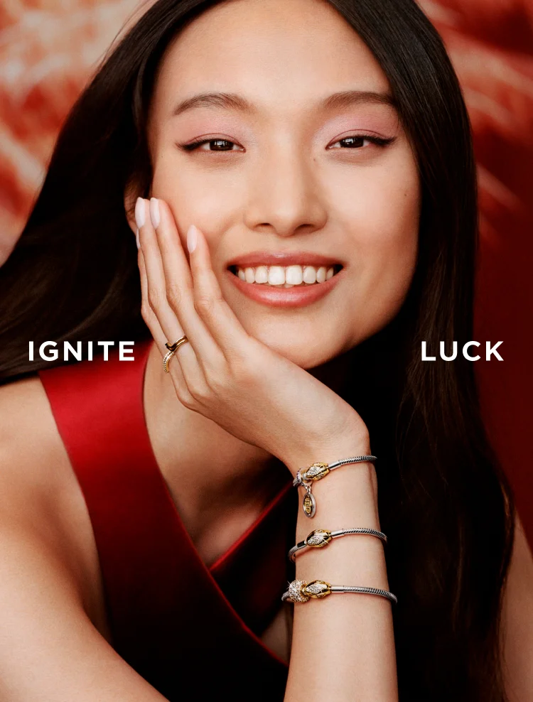 Smiling model wears Pandora Lunar New Year jewelry