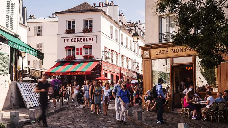 Image description: Tourists walking through Montmartre, Paris.