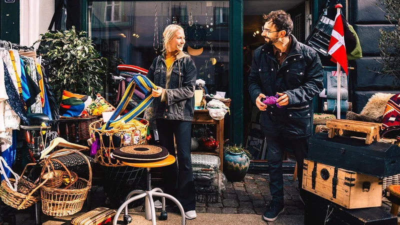 Image description: Two people at a thrift store in Copenhagen.