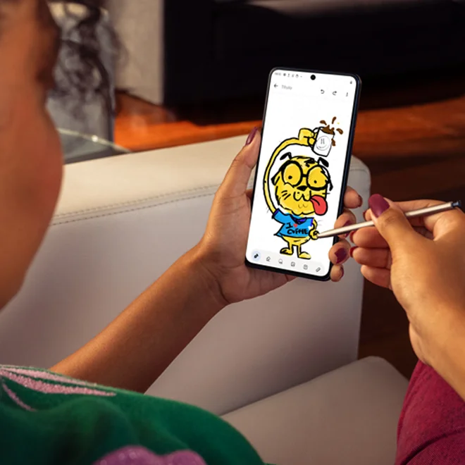 A woman drawing a picture of a cat with the new moto g stylus