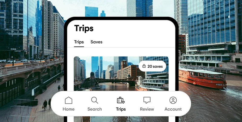 Image Description: A phone screen with a saved trip and an image of a city. Icons for “Home,” “Search,” “Trips,” “Review,” and “Account” are under it. An image of a red boat on a river surrounded by skyscrapers is behind the phone.