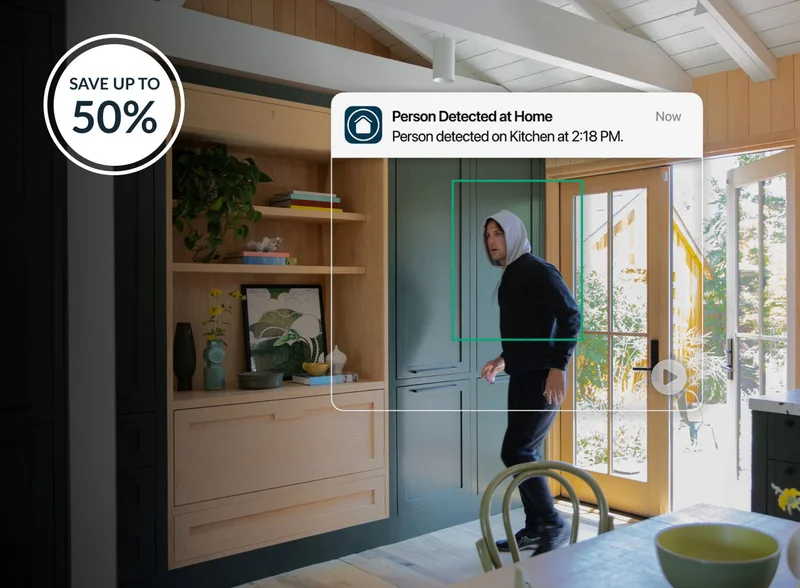 Up to 50% off. Image of burglar entering home with a simulated user interface showing an Arlo Secure notification detecting that a person was detected at home.