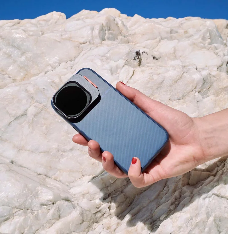 Image of someone holding an iphone with a Moment case and new QuickLock Filter