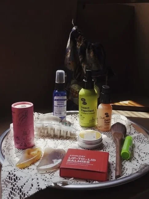 A platter with a lace cloth holds an assortment of body care products.