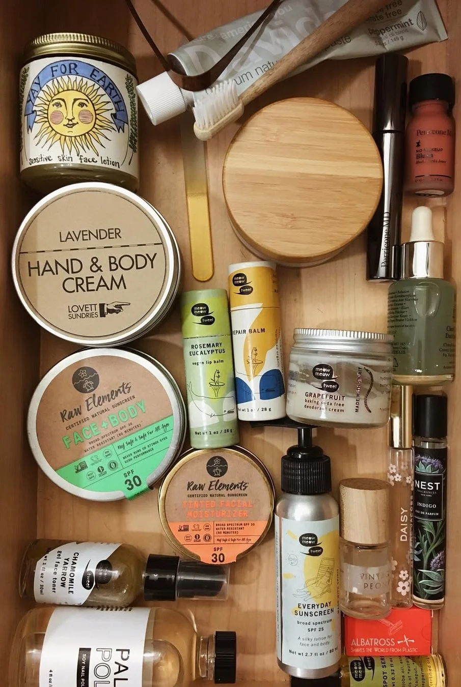 A birds eye view of a bathroom drawer. Inside is an array of toiletries and body care products.