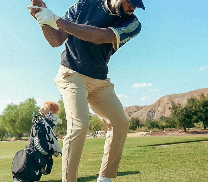Lebron James playing golf while wearing Nike special-edition Powerbeats Pro 2 earbuds