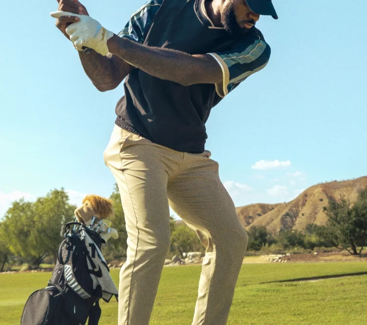 Lebron James playing golf while wearing Nike special-edition Powerbeats Pro 2 earbuds