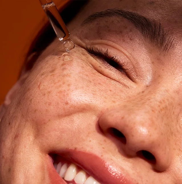 Model applying Bright Icon Vitamin C + E + Ferulic Serum