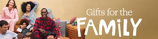 Gifts for the family. A group of women, men and kids wearing pajamas and slippers.