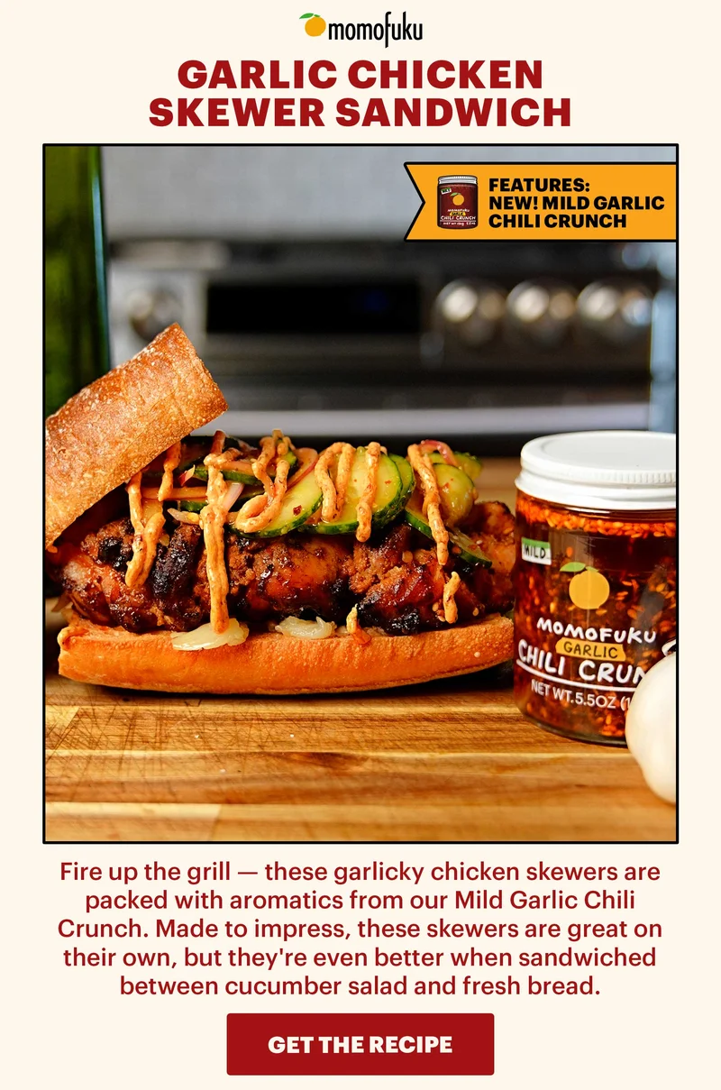 Header: Garlic Chicken Skewer Sandwich  Sub-header: Fire up the grill — these garlicky chicken skewers are packed with aromatics from our Mild Garlic Chili Crunch. Made to impress, these skewers are great on their own, but they're even better when sandwiched between cucumber salad and fresh bread.   Icon: Features: NEW! Mild Garlic Chili Crunch   CTA: GET THE RECIPE
