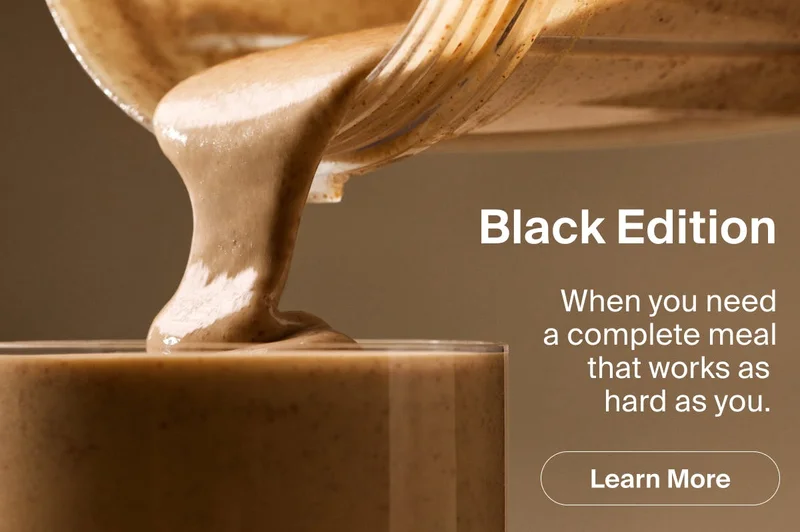 Huel Black Edition shaker pouring into glass — high protein, low carb complete meal