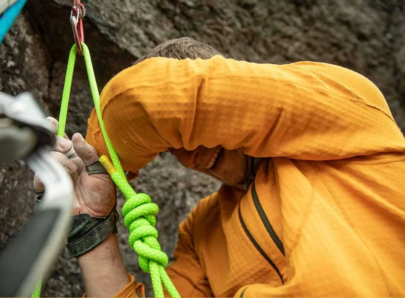 An exhausted climber smiles through the pain and joy of establishing a new route.