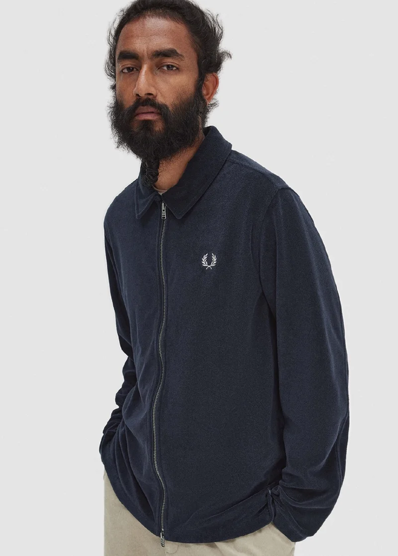 Man wearing navy towelling jacket