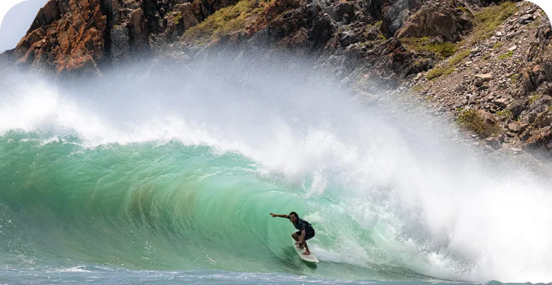 A surfer rides deep in the tube.