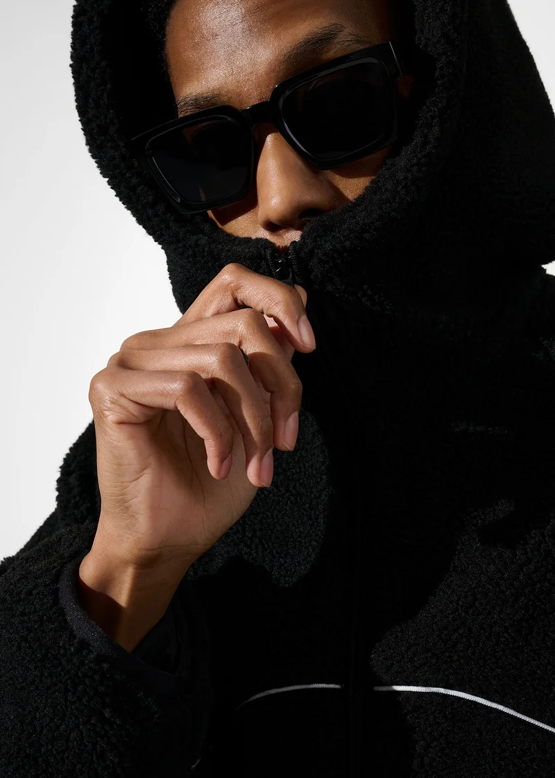 Closeup of model wearing the black astro fleece hoodie linking to product.