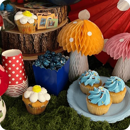 a Smurfs themed tablescape with mushrooms, moss, and treats a Smurfs themed tablescape with mushrooms, moss, and treats