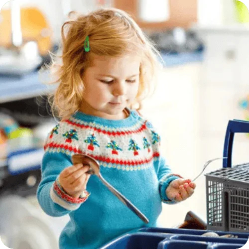 a little girl helping to sort cutlery from the dishwasher a little girl helping to sort cutlery from the dishwasher