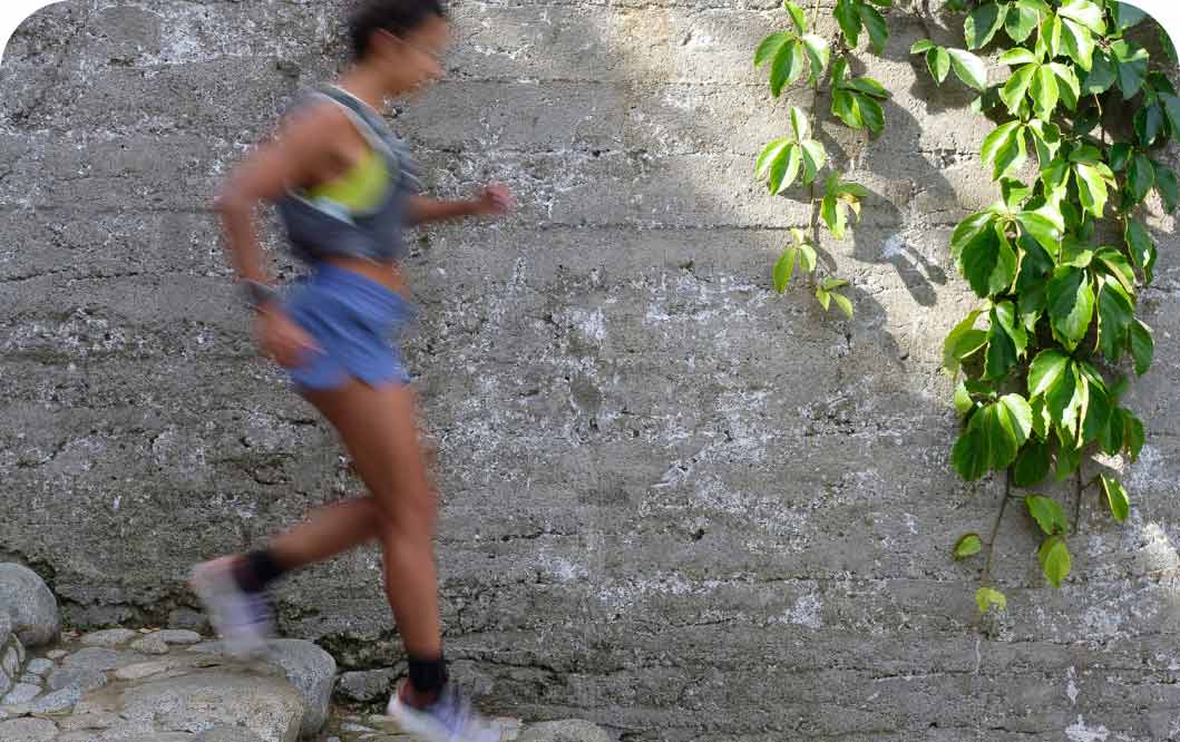 A person running on rock stairs.