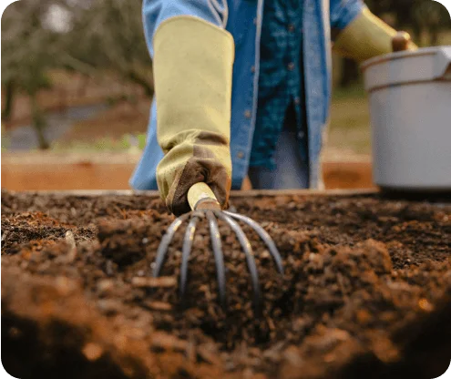 Photo of a person aerating compost