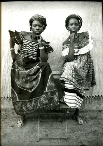 Portrait of two women in patterned dresses