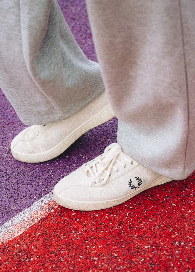 Close up of someone wearing the Fred Perry Tennis Shoe in Ecru