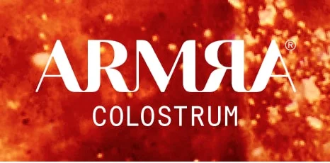 White ARMRA Colostrum logo displayed over a glowing red-orange textured background that resembles biological or scientific imagery.