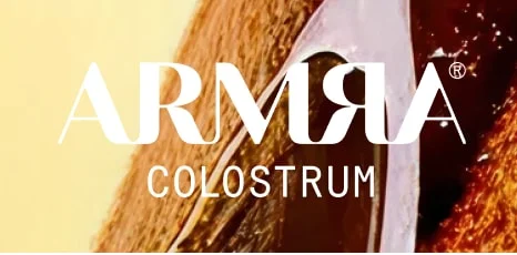 “ARMRA Colostrum” logo over a close-up, golden-toned liquid/texture background.