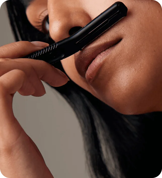 Black Dermaplaner shaving peach fuzz on upper lip