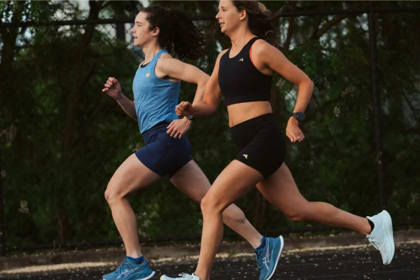 Two women running together