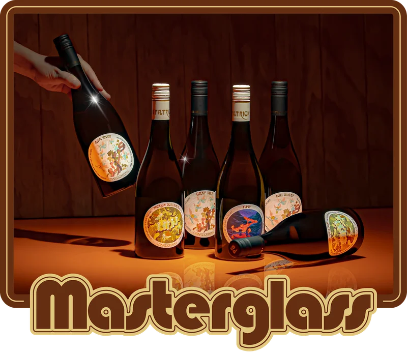 Lineup of Pat Sullivan wines on an orange bench with shadows from the lighting.