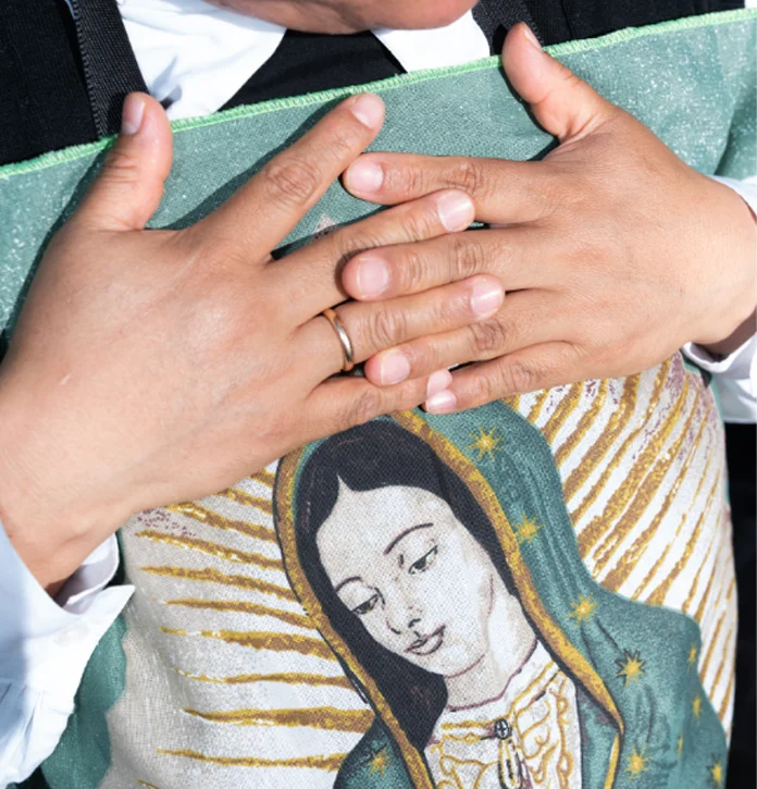 A nun holds an image of the Lady of Guadalupe while waiting for arrival of the new Pope in St Peter's square.