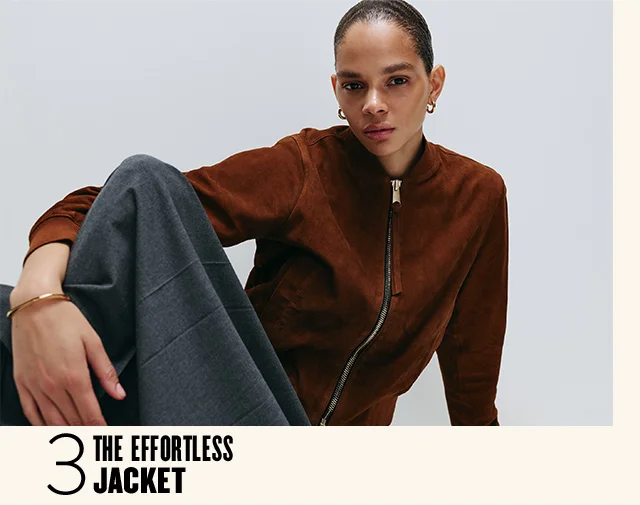 The effortless jacket: woman in a brown suede jacket and grey skirt.