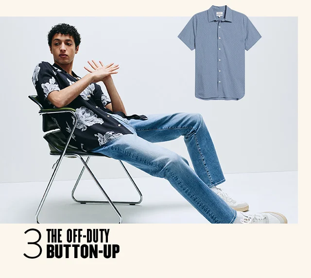 The off-duty button-up: seated man in a printed short-sleeve button, jeans and sneakers. A solid blue short-sleeve button-up.