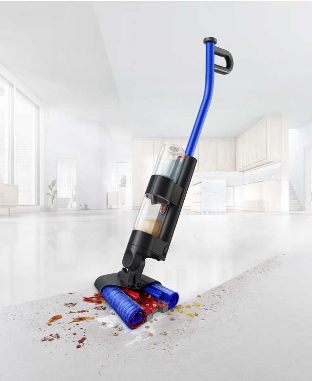 The Dyson WashG1 wet cleaner moving over wet and dry dirt, leaving a clean sweep behind it