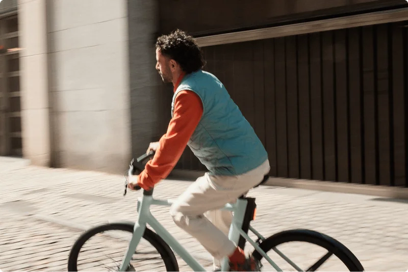 A photograph. A man sits on a Cowboy Cruiser Mint.