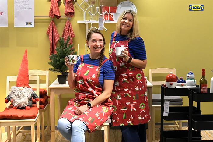 IKEA coworkers displaying winter holiday collection items