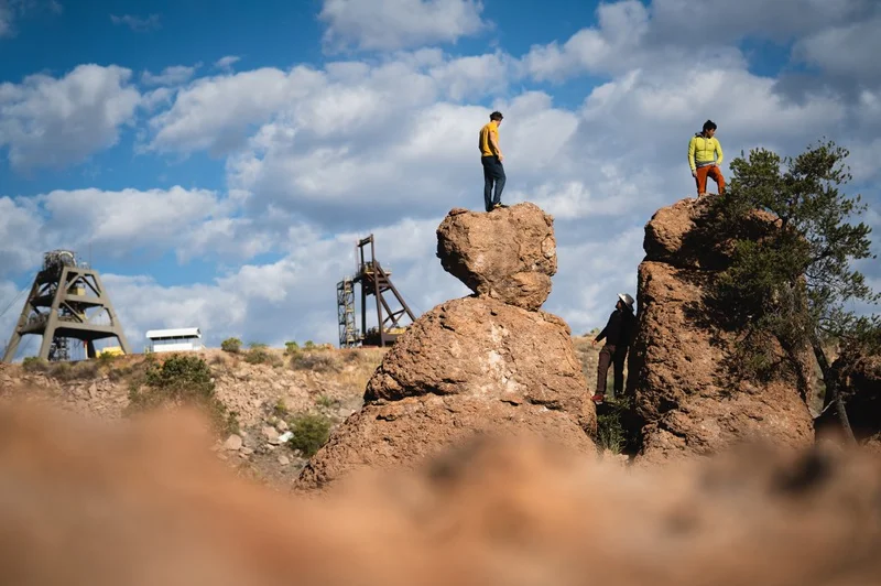 Two people standing on rocks.