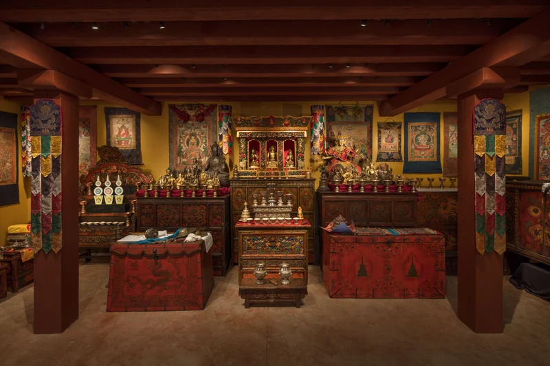 Tibetan Buddhist Shrine Room with artifacts, candles, and tapestries