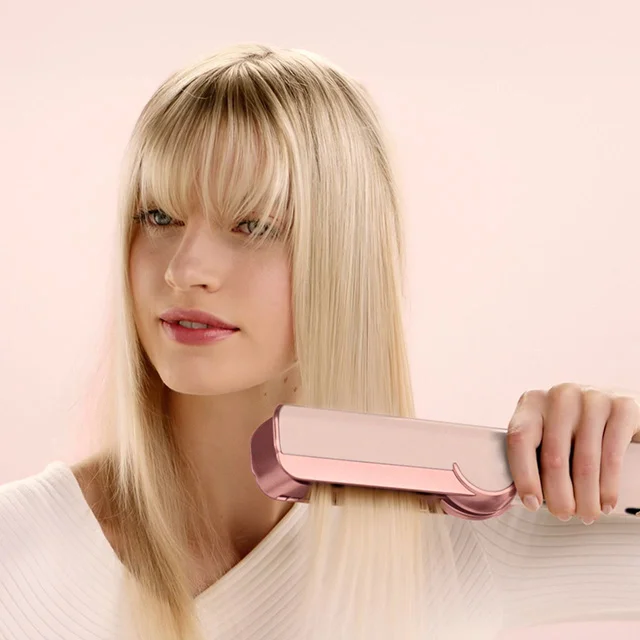Model smooths and dries her hair with the Dyson Airstrait wet-to-dry straightener in Ceramic pink and rose gold